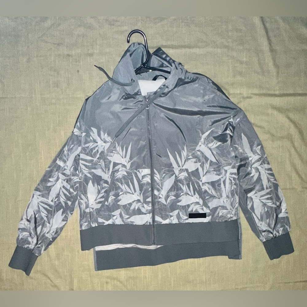 CK Light gray wind/rain jacket. It’s in good shape with no damage.